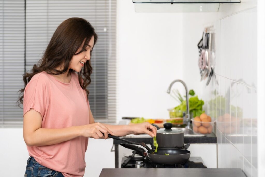 happy-young-woman-cooking-preparing-food