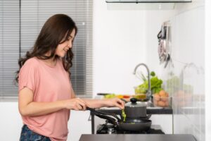 happy-young-woman-cooking-preparing-food